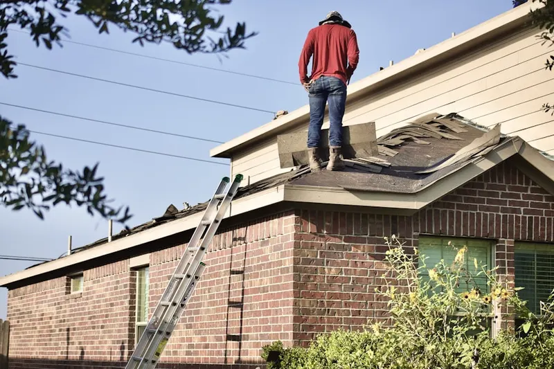 Professional roofer working on a residential roof in East Woodstock